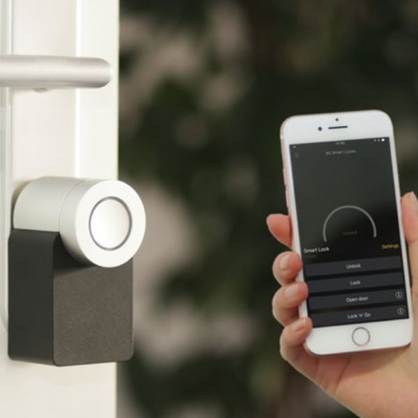 Image showcasing IoT devices, including a smart door lock and a mobile device." Title: "Smart IoT Devices - Door Lock and Mobile